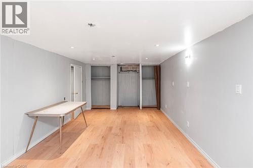 Spacious room with wood-finish flooring, light grey walls, recessed ceiling lighting, and built-in closet storage - 112 Nash Road S, Hamilton, ON - Indoor Photo Showing Other Room