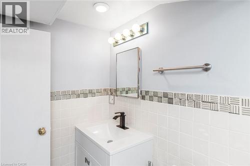 Vanity with integrated sink and matte black faucet - 112 Nash Road S, Hamilton, ON - Indoor Photo Showing Bathroom