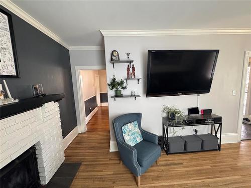450 3Rd Street, Brandon, MB - Indoor Photo Showing Living Room With Fireplace