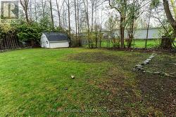 fenced in backyard with shed - 