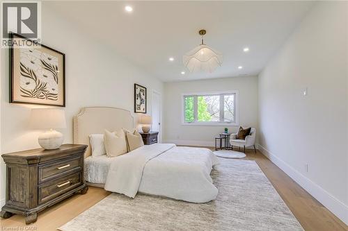 Light wood-finish flooring complements the neutral wall tones - 1411 Mountain Grove Avenue, Burlington, ON - Indoor Photo Showing Bedroom
