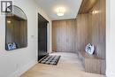 Entryway featuring custom wood-finish built-in cabinetry, wood-finish flooring, a built-in bench, and a modern ceiling light fixture - 1411 Mountain Grove Avenue, Burlington, ON  - Indoor Photo Showing Other Room 