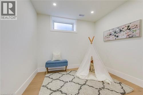 Bright room featuring a window, recessed lighting, and wood-finish flooring with white baseboards - 1411 Mountain Grove Avenue, Burlington, ON - Indoor
