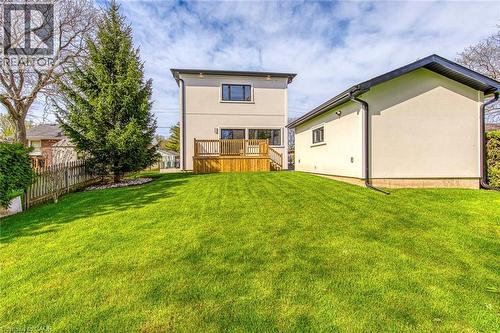 Expansive green lawn with a wooden fence and mature evergreen tree - 1411 Mountain Grove Avenue, Burlington, ON - Outdoor With Deck Patio Veranda