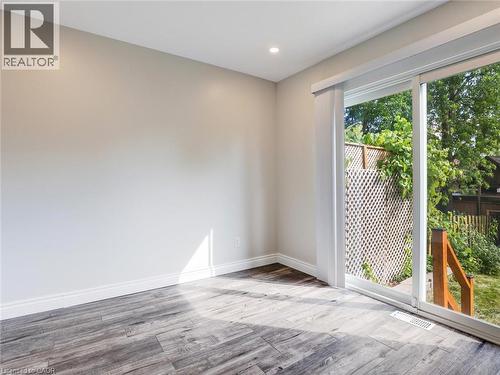Spacious room with wood-finish flooring and recessed ceiling lighting - 833 Doon Village Road, Kitchener, ON - Indoor Photo Showing Other Room