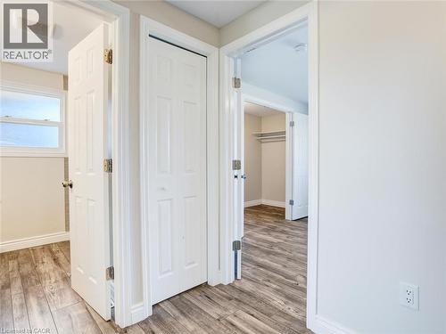 Hallway featuring durable wood-finish flooring, white trim, and light wall paint - 833 Doon Village Road, Kitchener, ON - Indoor Photo Showing Other Room