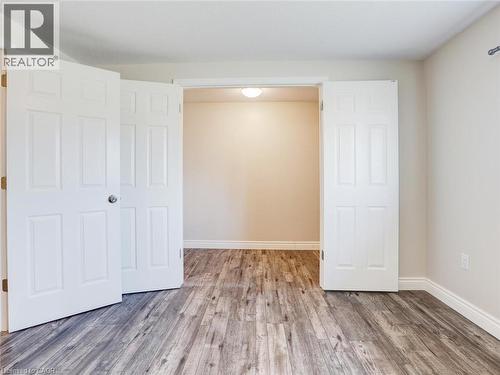 Double interior doors opening to a separate room, featuring wood-finish flooring - 833 Doon Village Road, Kitchener, ON - Indoor Photo Showing Other Room