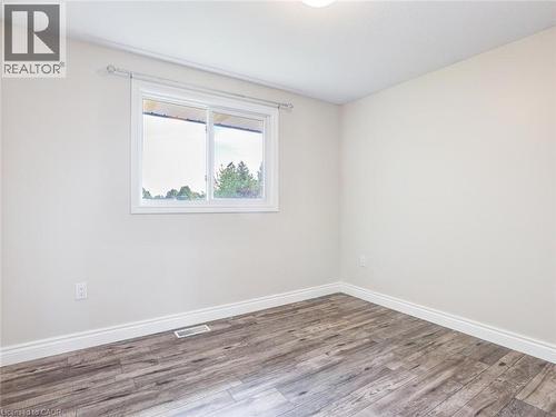 Room featuring wood-finish flooring, white baseboards, and neutral wall tones - 833 Doon Village Road, Kitchener, ON - Indoor Photo Showing Other Room