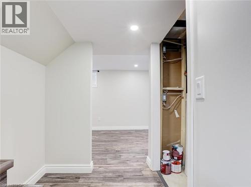 Wood-finish flooring throughout, complemented by crisp white walls and recessed ceiling lighting - 833 Doon Village Road, Kitchener, ON - Indoor Photo Showing Other Room
