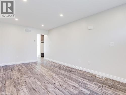 Spacious room featuring wood-finish flooring, recessed lighting, and white baseboards - 833 Doon Village Road, Kitchener, ON - Indoor Photo Showing Other Room