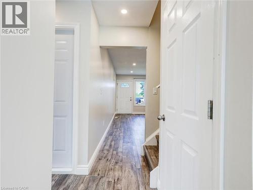 Entryway featuring wood-finish flooring, recessed lighting, and a white paneled door - 833 Doon Village Road, Kitchener, ON - Indoor Photo Showing Other Room