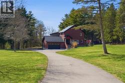 View of front of house with a front lawn, an attached garage, and driveway - 