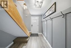 Mudroom with a textured ceiling and light wood-style floors - 