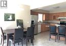 Open-concept kitchen and dining area featuring light-toned cabinetry, stainless steel appliances, and a breakfast bar - 350 Havendale Crescent, Waterloo, ON  - Indoor 
