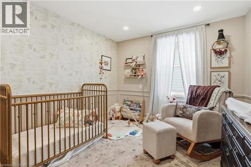 Room featuring recessed lighting, a large window with privacy blinds, and decorative wainscoting - 47 New Street, Hamilton, ON - Indoor