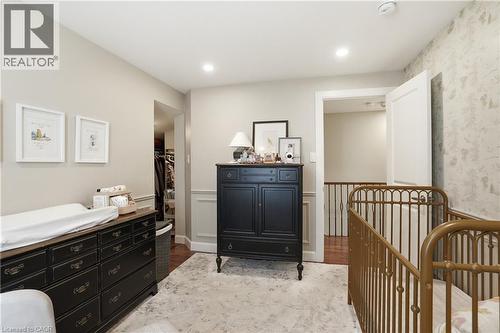 Bedroom featuring recessed lighting, a wide doorway, a closet with built-in shelving, and wainscoting detail - 47 New Street, Hamilton, ON - Indoor