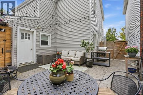 Outdoor patio featuring string lighting, paver stone flooring, and privacy fencing - 47 New Street, Hamilton, ON - Outdoor With Deck Patio Veranda