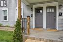 Gray vinyl siding exterior featuring two individual entry doors with transom window details - 47 New Street, Hamilton, ON  - Outdoor With Exterior 