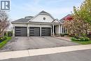 Light brick exterior with white siding accents and a covered entryway - 4285 Couples Crescent, Burlington, ON  - Outdoor With Facade 