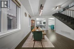 Interior space featuring dark wood-finish flooring, white baseboards, and white walls - 
