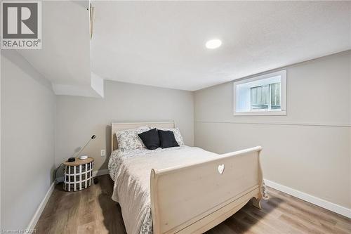 Inviting room featuring wood-finish flooring, recessed ceiling lighting, and a white-trimmed window - 15 Gordon Avenue, Kitchener, ON - Indoor Photo Showing Bedroom