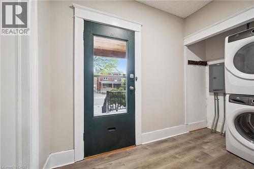 Neutral wall paint, wood-finish flooring, and white trim work - 15 Gordon Avenue, Kitchener, ON - Indoor Photo Showing Laundry Room