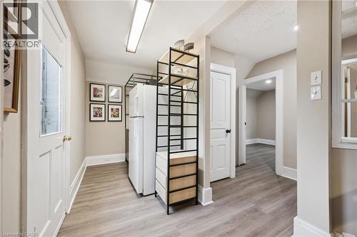 Hallway featuring wood-finish flooring, white trim, and neutral wall tones - 15 Gordon Avenue, Kitchener, ON - Indoor Photo Showing Other Room