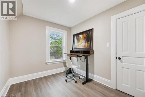 Room featuring wood-finish flooring, neutral wall paint, and white trim - 15 Gordon Avenue, Kitchener, ON - Indoor