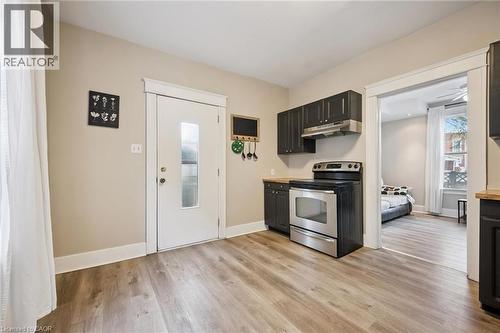 Kitchen featuring dark wood-finish cabinetry, stainless steel range and range hood, and wood-finish countertops - 15 Gordon Avenue, Kitchener, ON - Indoor Photo Showing Kitchen