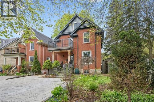 Brick exterior with stone foundation accents and a gabled roofline - 15 Gordon Avenue, Kitchener, ON - Outdoor