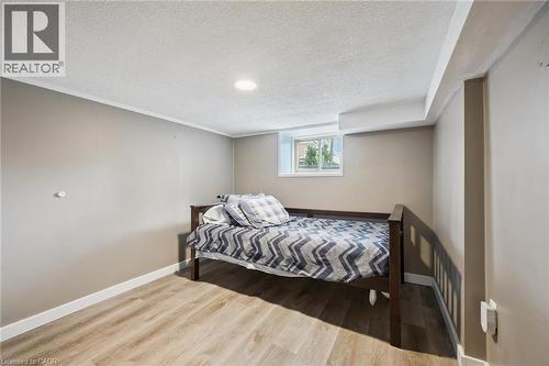 Room featuring light wood-finish flooring, neutral wall paint, and white trim - 15 Gordon Avenue, Kitchener, ON - Indoor Photo Showing Bedroom