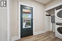 Neutral wall paint, wood-finish flooring, and white trim work - 