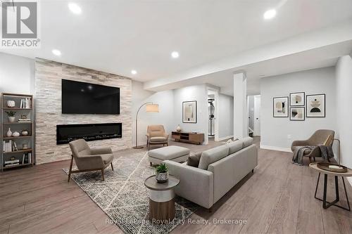 Virtually staged recreation room - 5 Sandybay Avenue, Kitchener, ON - Indoor Photo Showing Living Room With Fireplace