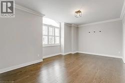 Spacious room with rich wood-finish flooring - 