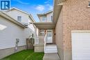 Brick and siding exterior featuring a covered front porch with white railings, a white garage door, and a concrete walkway - 425 Erinbrook Drive, Kitchener, ON  - Outdoor With Exterior 