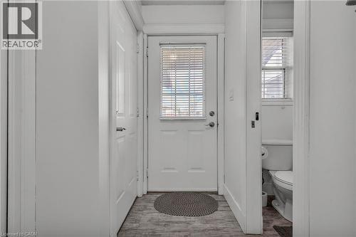 Entryway featuring wood-finish flooring, a paneled door with integrated blinds, and painted trim - 425 Erinbrook Drive, Kitchener, ON - Indoor Photo Showing Other Room