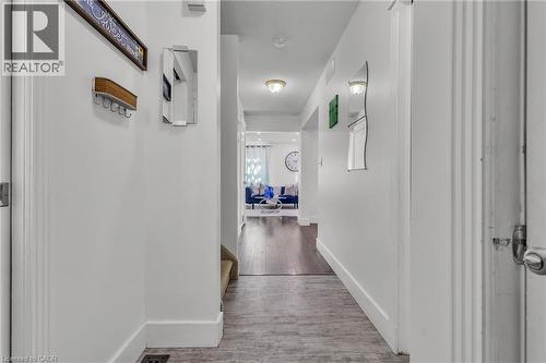Hallway featuring wood-finish flooring transitioning to a darker wood-finish, white walls, and recessed lighting - 425 Erinbrook Drive, Kitchener, ON - Indoor Photo Showing Other Room