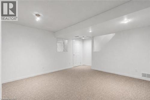 Spacious room featuring light-toned carpet flooring, white painted walls, and recessed lighting - 425 Erinbrook Drive, Kitchener, ON - Indoor Photo Showing Other Room