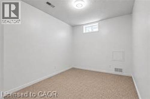 Neutral-toned carpeting paired with light-colored walls - 425 Erinbrook Drive, Kitchener, ON - Indoor Photo Showing Other Room
