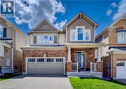 Two-story facade featuring a brick first level, siding second level, a gabled roofline, and an attached two-car garage - 19 Shoreacres Drive, Kitchener, ON - Outdoor With Facade