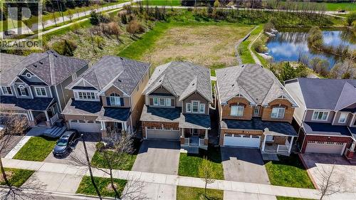 Two-story residence featuring a two-car garage, front porch, and dormer windows - 19 Shoreacres Drive, Kitchener, ON - Outdoor With Facade