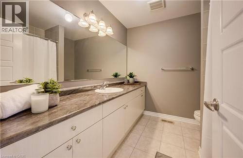 Bathroom featuring an extended vanity with a stone-finish countertop and an integrated sink - 19 Shoreacres Drive, Kitchener, ON - Indoor Photo Showing Bathroom