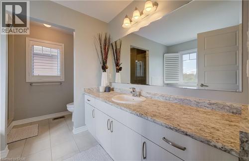 Spacious vanity featuring a light-toned countertop, dual under-mount sinks, and extensive cabinetry - 19 Shoreacres Drive, Kitchener, ON - Indoor Photo Showing Bathroom