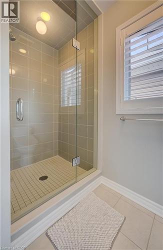 Glass-enclosed shower featuring large format wall tiles, a tiled shower pan, recessed lighting, and a rainfall showerhead - 19 Shoreacres Drive, Kitchener, ON - Indoor Photo Showing Bathroom