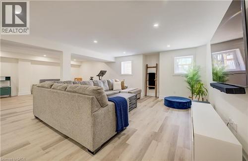 Spacious lower-level area featuring recessed lighting, light wood-finish flooring, and multiple windows - 19 Shoreacres Drive, Kitchener, ON - Indoor