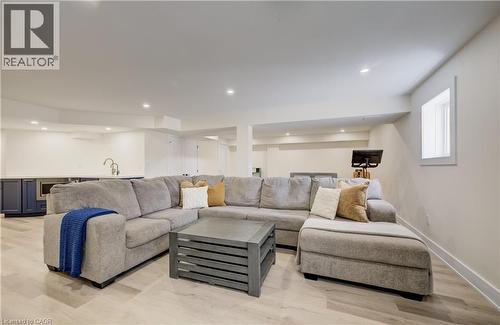 Spacious recreation room featuring recessed lighting, light wood-finish flooring, and a window providing natural illumination - 19 Shoreacres Drive, Kitchener, ON - Indoor Photo Showing Living Room