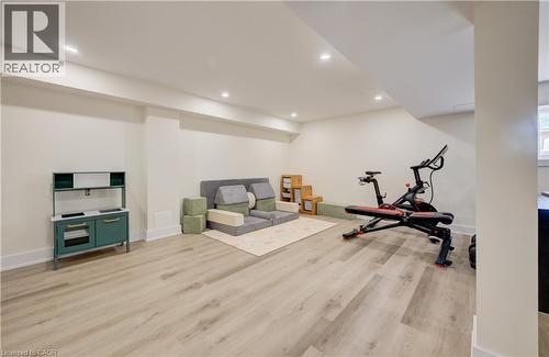 Spacious finished basement featuring recessed lighting, light wood-finish flooring, and white baseboards - 19 Shoreacres Drive, Kitchener, ON - Indoor Photo Showing Gym Room