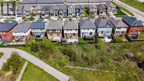 Rear exterior of multiple residential properties with pitched shingle roofs and varied siding finishes - 19 Shoreacres Drive, Kitchener, ON - Outdoor