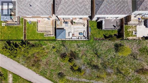 Expansive backyard featuring a large wooden deck, a covered patio area, and a lush green lawn - 19 Shoreacres Drive, Kitchener, ON - Outdoor