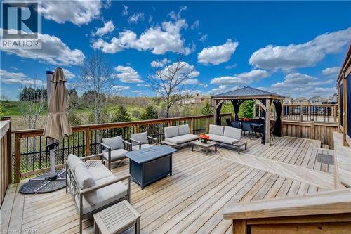 Multi-level wood deck featuring a covered gazebo, black metal railings, and a fire pit - 19 Shoreacres Drive, Kitchener, ON - Outdoor With Deck Patio Veranda